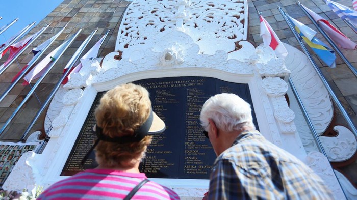Family members and relatives of victims of the 2002 Bali Bombings throw flowers while visiting the memorial during ceremonies marking the 24th anniversary of the 2002 Bali bombings, in Kuta, Bali, Indonesia, October 12, 2026. REUTERS/Johannes Christo