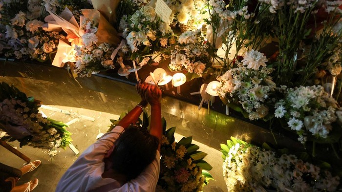 Family members and relatives of victims of the 2002 Bali Bombings throw flowers while visiting the memorial during ceremonies marking the 24th anniversary of the 2002 Bali bombings, in Kuta, Bali, Indonesia, October 12, 2026. REUTERS/Johannes Christo