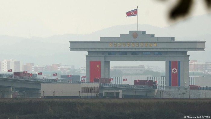 Bendera China dan Korea Utara menghiasi jembatan yang diresmikan pada Kamis (15/10) (Florence Lo/REUTERS)