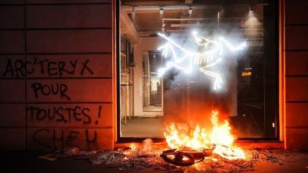 Protesters break windows of a French food company 'Picard' shop during a demonstration against the 