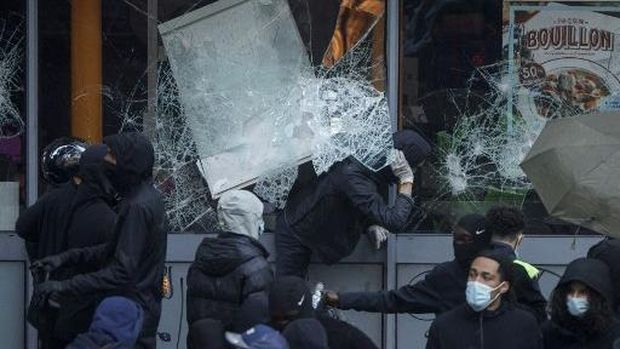 Protesters break windows of a French food company 'Picard' shop during a demonstration against the 
