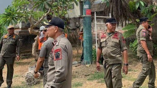 Satpol PP Badung mengawasi pembersihan tower di dekat Puspem Badung, Senin (19/10/2026). (Foto: Dok. Istimewa)