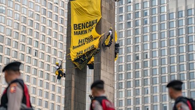 Greenpeace Bentangkan Spanduk di Patung Bundaran HI