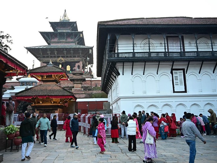 KATHMANDU, NEPAL - OCTOBER 20: Devotees queue to visit Taleju Bhawani Temple during Maha Nawami, the ninth day of the Dashain festival, at Hanuman Dhoka Durbar Square in Kathmandu, Nepal, on October 20, 2026. Located within the former royal palace complex, the historic temple opens to the public only once a year on Maha Nawami, attracting large numbers of worshippers seeking blessings from Goddess Taleju Bhawani. According to a 2025 report, around 500,000 devotees visited the temple on Maha Nawami in 2024. The temple is also associated with a jewel-studded necklace commissioned by King Pratap Malla, which disappeared in 1976 and later surfaced at the Art Institute of Chicago in the United States. The necklace was removed from public display in August 2025 amid efforts to secure its return to Nepal. Dashain, Nepalâs major Hindu festival, celebrates the victory of good over evil and honours Goddess Durga. Maha Nawami is marked by special prayers, worship and traditional animal sacrifice rituals at temples and shrines across the country. (Photo by Safal Prakash Shrestha/Anadolu via Getty Images)