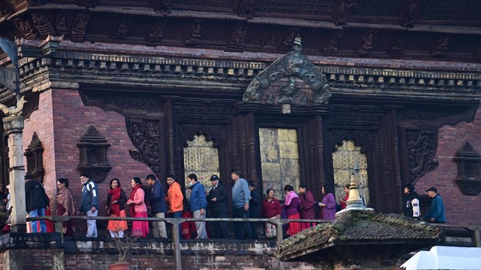 KATHMANDU, NEPAL - OCTOBER 20: Devotees queue to visit Taleju Bhawani Temple during Maha Nawami, the ninth day of the Dashain festival, at Hanuman Dhoka Durbar Square in Kathmandu, Nepal, on October 20, 2026. Located within the former royal palace complex, the historic temple opens to the public only once a year on Maha Nawami, attracting large numbers of worshippers seeking blessings from Goddess Taleju Bhawani. According to a 2025 report, around 500,000 devotees visited the temple on Maha Nawami in 2024. The temple is also associated with a jewel-studded necklace commissioned by King Pratap Malla, which disappeared in 1976 and later surfaced at the Art Institute of Chicago in the United States. The necklace was removed from public display in August 2025 amid efforts to secure its return to Nepal. Dashain, Nepalâs major Hindu festival, celebrates the victory of good over evil and honours Goddess Durga. Maha Nawami is marked by special prayers, worship and traditional animal sacrifice rituals at temples and shrines across the country. (Photo by Safal Prakash Shrestha/Anadolu via Getty Images)