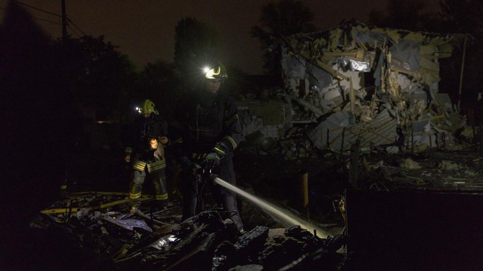 KYIV, UKRAINE - OCTOBER 22: A firefighter of the State Emergency Service of Ukraine extinguishes smouldering debris in front of a destroyed private house following an aerial attack on October 22, 2026 in Kyiv, Ukraine. According to initial reports, Russia fired around 30 ballistic missiles at Ukraine overnight, striking energy infrastructure. In Kyiv, six people were injured, according to Mayor Vitali Klitschko. (Photo by Diego Fedele/Getty Images)