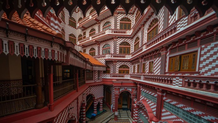 1250863895 An inside view of the red mosque in Colombo, Sri Lanka, on April 7, 2023. The Colombo Red Mosque, also known as Jami Ul-Alfar Masjid, is literally an architectural wonder for the world that would stun you with its unusual color patterns and unconventional yet amazing design. Located in Colombo district, this oldest mosque towers over the buildings and streets in the neighborhood with its tall minarets and was once a reliable landmark for the sailors coming towards Colombo port. Colombo had always been a welcoming hub for international trade, where Arabs frequently visited and populated enormously. They had to perform their five mandatory daily rituals. For that reason, the Indian Muslim Community was commissioned to put up a mosque in Pettah. Work commenced in 1908, and the construction of the Colombo Red Mosque (Jami-Ul-Alfar Mosque) was finished in just one year. Habibu Labbe Saibu Labbe was the chief designer of the building, and he relied on Indo-Saracenic and Neo-classical architectural styles. In 1975, the mosques capacity was extended to as much as 10,000. The oldest mosque in Colombo is literally an interesting tourist destination. (Photo by Thilina Kaluthotage/NurPhoto via Getty Images)