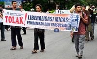 Massa HTI mensosialisasikan penolakan liberalisasi Migas pada warga yang melintasi aksinya.