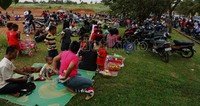 Para pengendara motor beristirahat di pinggir jalan menunggu berakhirnya kemacetan.