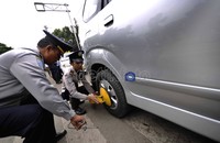 Petugas menggembok roda mobil yang diparkir sembarangan. Jhoni Hutapea/detikcom.
