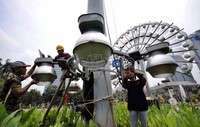Petugas mengganti lampu penerangan jalan di kawasan Monas, Jakarta, Jumat (24/2/2012).