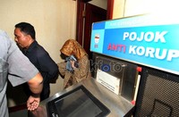 Nunun memasuki ruang terdakwa dengan pengawalan ketat.