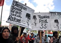 Para demonstran membawa poster bergambar Bung Karno serta tuntutan jaminan sosial rakyat miskin dan pengimplementasian Pasal 33 UUD 1945.
