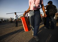 Seorang petugas mengevakuasi kotak hitam pesawat. Reuters/Navesh Chitrakar.