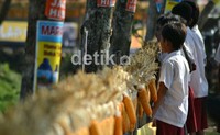 Untaian jagung tersebut menarik perhatian warga yang melintas termasuk anak sekolah.