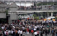 Warga melihat dari atas jembatan busway yang tidak jauh dari lokasi.
