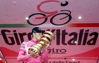Ryder Hesjedal mencium trofi di atas podium. Reuters/Alessandro Garofalo.