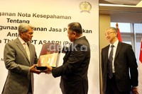 Presiden Direktur CIMB NIaga Arwin Rasyid (kiri) menerima cinderamata pisau komando TNI dari Dirut ASABRI Adam R Damiri (tengah).