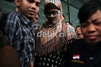 Neneng yang mengenakan kerudung kotak-kotak mirip motif Burberry ini menutupi wajahnya dengan kerudung. Ibu tiga anak ini melengkapi penampilannya dengan kacamata. Ia digiring masuk ke dalam mobil tahanan yang sudah menunggu di depan KPK. Ramses/detikcom.