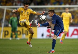 Yevhen Konoplyanka berebut bola dengan Mathieu Debuchy dalam laga yang digelar di Donbass Arena, Donetsk. Reuters/Michael Buholzer.