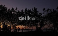 Wisatawan menikmati panorama Pantai Labuan Bajo dengan sunset indahnya.