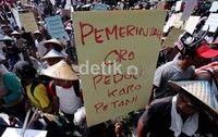 Mereka membawa berbagai poster, salah satunya bertuliskan Pemerintah ora peduli karo petani