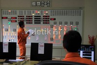 Pekerja melihat alat kontrol kinerja generator.