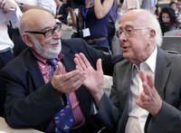 Peter Higgs (kanan) berbincang dengan ahli fisika asal Belgia Francois Englert beberapa waktu lalu.  Higgs sangat senang karena bisa menyaksikan penemuan yang membuktikan teorinya. Meski demikian, ia tak senang partikel Higgs dijuluki partikel Tuhan. Sebab, Higgs adalah seorang atheis. (Reuters/Denis Balibouse).