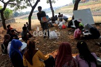 Seorang mentor menjelaskan tentang cara lukisan.