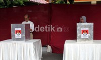Faisal dan istri melakukan pencoblosan.