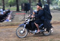 Sepasang anggota jamaah An Nadzir berangkat dengan sepeda motor menuju tanah lapang tempat pelaksanaan shalat Id.