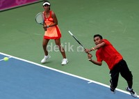 Ega Uneputty (kanan) berusaha mengembalikan bola lawan pada pertandingan semifinal di nomor ganda campuran.