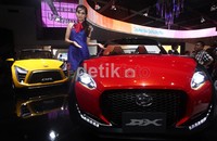 Seorang model berpose dengan Daihatsu D-X di ajang Indonesia International Motor Show (IIMS) 2012 di JI Expo Kemayoran, Jakarta Utara.