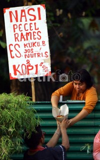 Seorang pedagang melayani pembeli dari balik pagar. Ramses/detikcom.