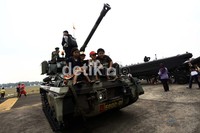 Sekelompok anak menaiki tank.