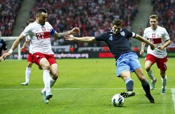 Steven Gerrard (kanan) berusaha melewati Marcin Wasilewski (kiri). Reuters/Darren Staples.