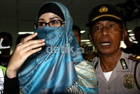 Neneng meninggalkan ruang sidang dengan dikawal beberapa polisi. Ramses/detikcom.