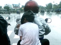 Si anak hanya diberi tas plastik hitam untuk menutupi kepalanya. Dengan hanya dibalut kaos, si anak kedinginan. (Foto Didacus Pindho Bismoko)