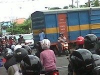 Ketika pintu perlintasan kereta ditutup ada seorang ibu yang nekat  menerobos palang pintu, dia nekat berhenti diantara rel, dan  beberapa saat kemudian kereta lewat, untung saja tidak terserempet. (Foto: Zainun)