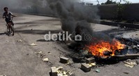 Asap hitam mengepul dari ban yang dibakar warga.