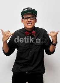Ilham memadukan kemeja hitam polosnya dengan dasi kupu-kupu merah. Gusmun/detikHot.