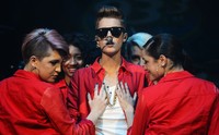 Justin diiringi para dancer berkostum merah. Michael Kovac/Getty Images for Jingle Ball 2012.