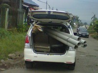 Mobil dipergunakan membawa kayu dan pipa hingga menutupi lampu belakang di daerah Kota Bunga, Cipanas. Pintu bagasi harus dibuka. Foto Ari Karno.     