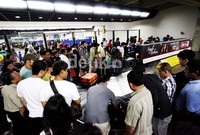 Para penumpang memadati ruangan pengambilan barang.