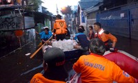 Para relawan menyusuri jalanan yang tergenang menggunakan perahu karet. (Dok Astra).