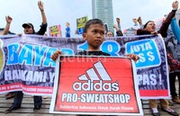Seorang anak ikut berdemo dan membentangkan poster.