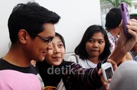 Seorang penggemar mengabadikan gambar dirinya dengan Afgan. Gusmun/detikFoto.