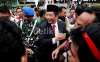 Mahfud menyapa warga saat berjalan menuju mobilnya.