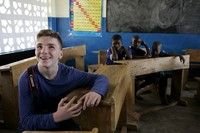 Rocco, putra kandung Madonna terlihat terseyum di ruang kelas. AFP/Amos Gumulira.