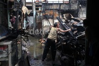 Warga mencari barang-barang sisa kebakaran.
